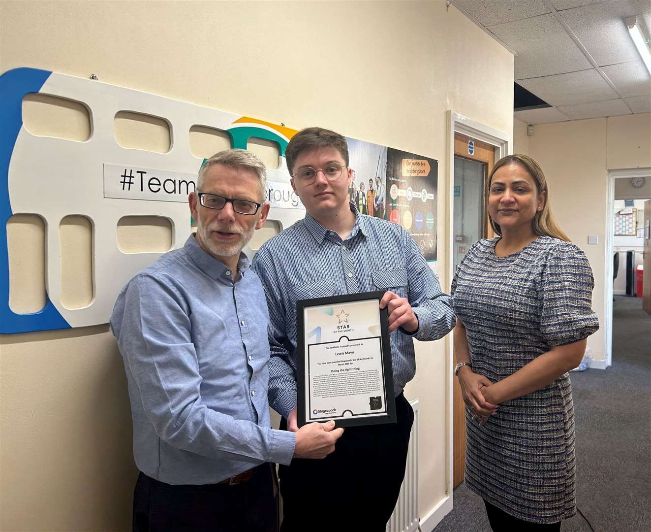 Driver Lewis Mayo, centre, receives his award from Darren Roe and Hema Russell