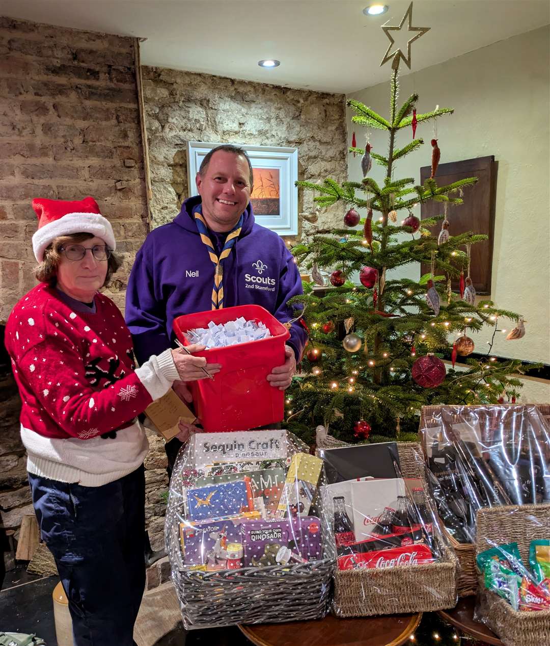 Pauline Jones and Neil Scholes draw the raffle winners.