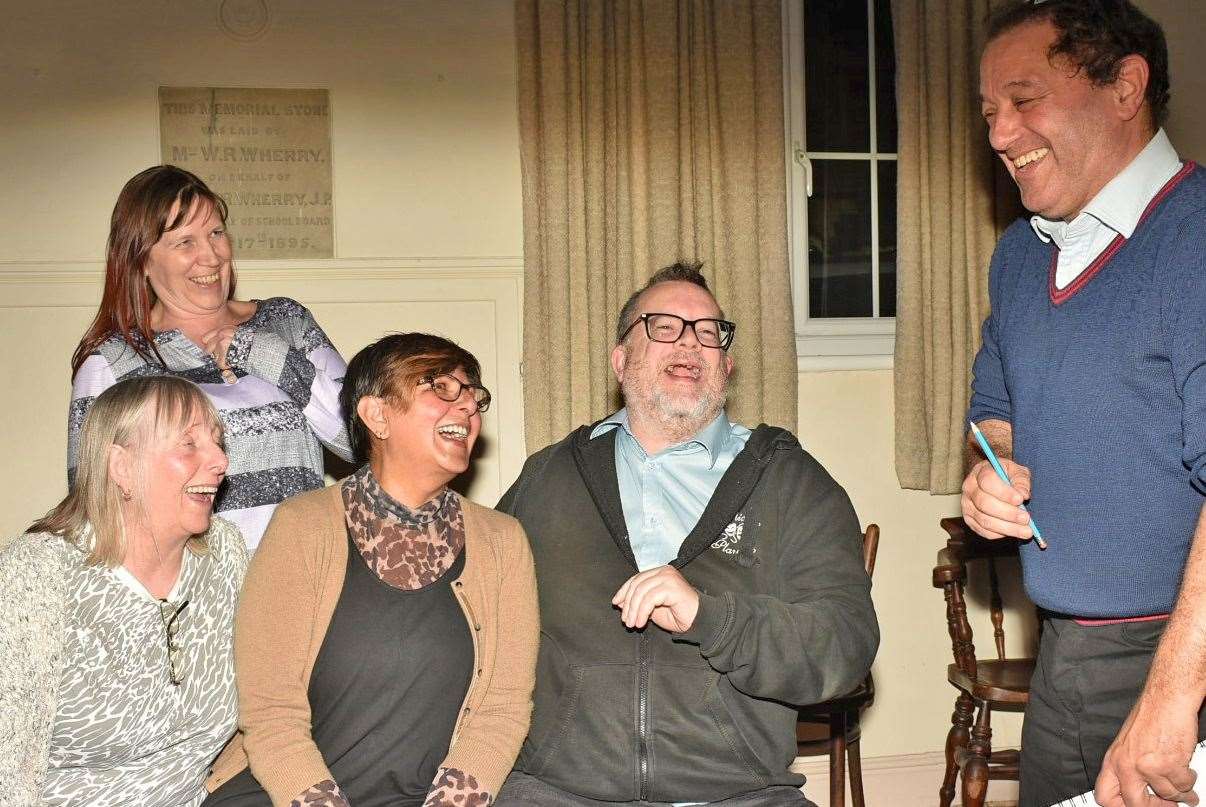 The cast share a chuckle with director Michael Hughes