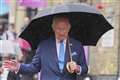 King visits London market after braving summer showers