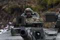 William rides in tank on visit to British troops helping defend Estonia