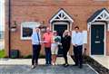 Developers present gifts to couple as they move into new home