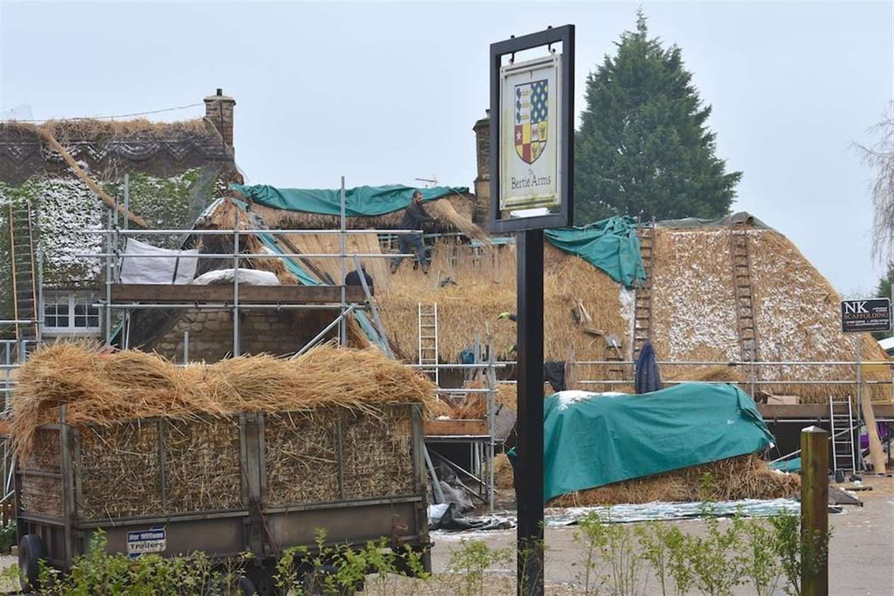 The old straw will be used on the roofs of Bronze and Stone Age huts at Copthill School, Uffington