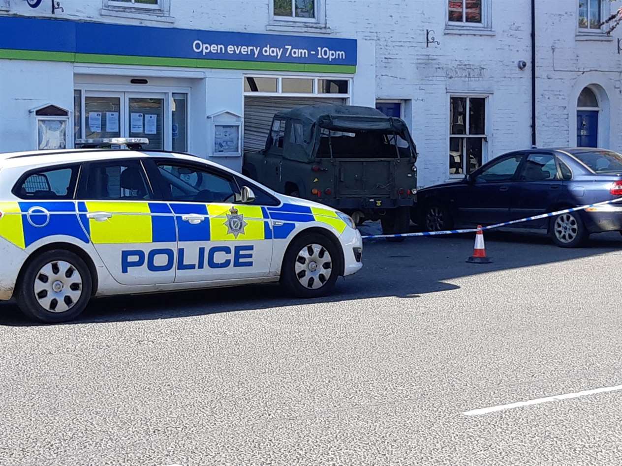 A green Land Rover is lodged in the window of the Lincolnshrie Coop store in Crowland (34378190)