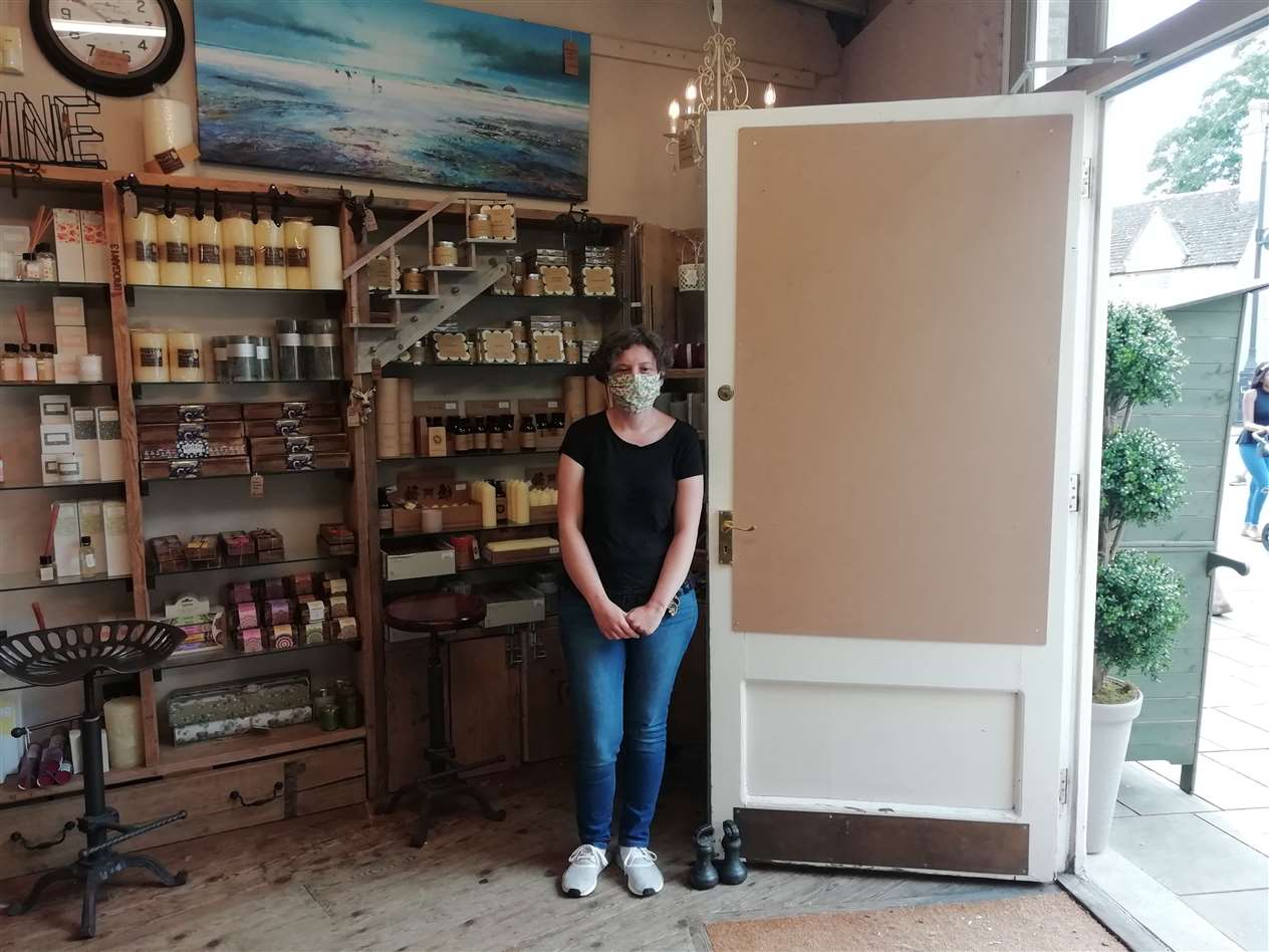 Linda Christian, shop assistant at The Nook in Sheep Market, Stamford, with the boarded up window