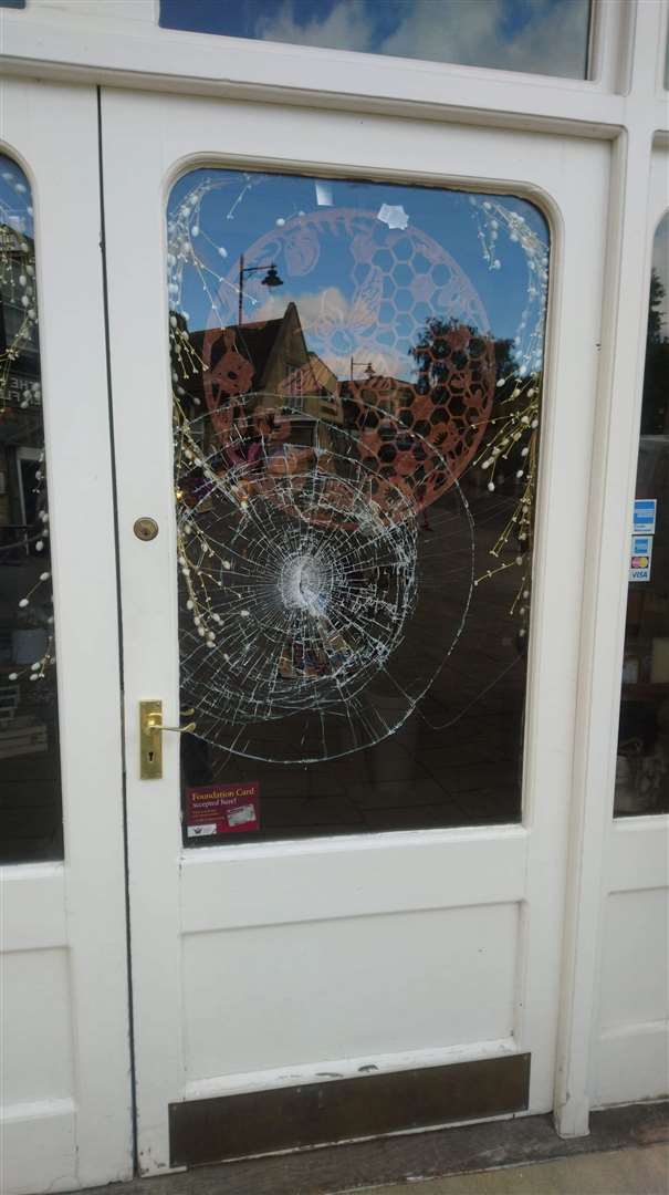 The smashed front window of The Nook in Sheep Market, Stamford