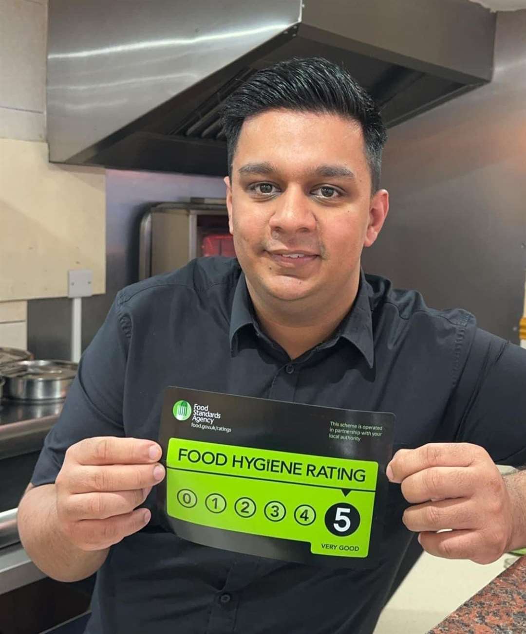 Fakhar Majeed manager at New Eastern Spice in Crowland shows off the top food hygiene rating. PHOTO: SUBMITTED