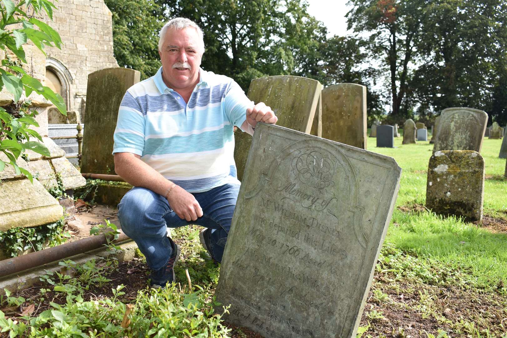 Churchyard volunteer Geoff Reynolds next to the Disneys' grave (15016843)