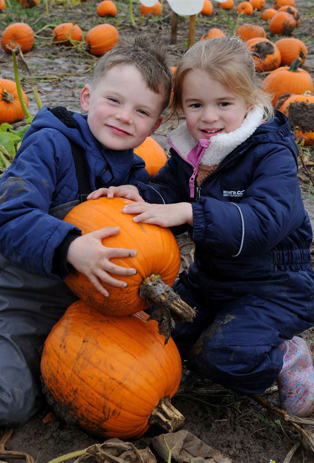 Rory and Orla looking pleased with their pumpkins
