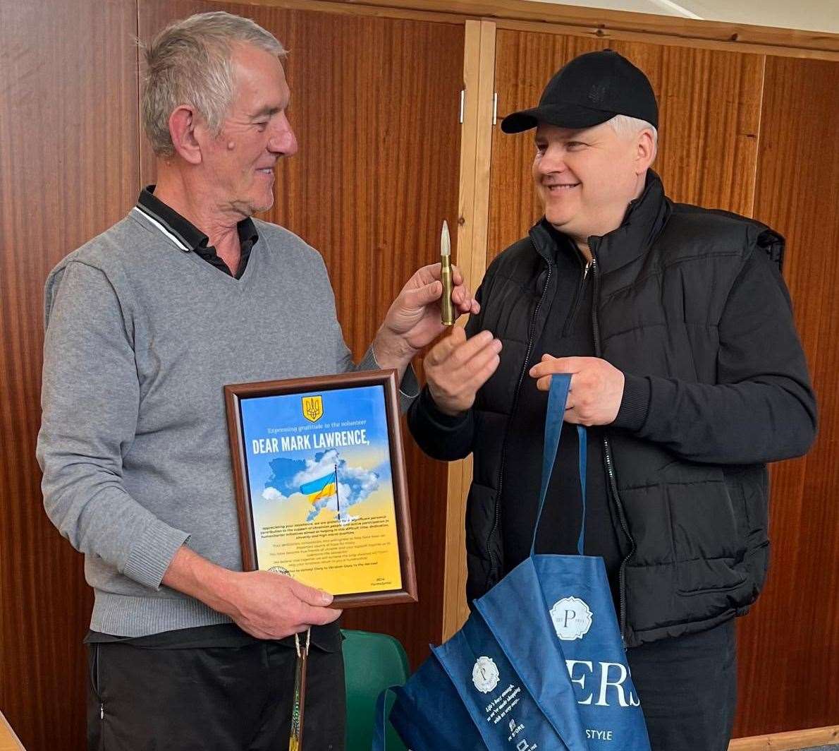 Stamford-based Ukranian Mykola presents Mark Lawrence (left) with a certificate of thanks from the Mayor of Yarmolyntsi and a trench torch made by Ukrainian soldiers
