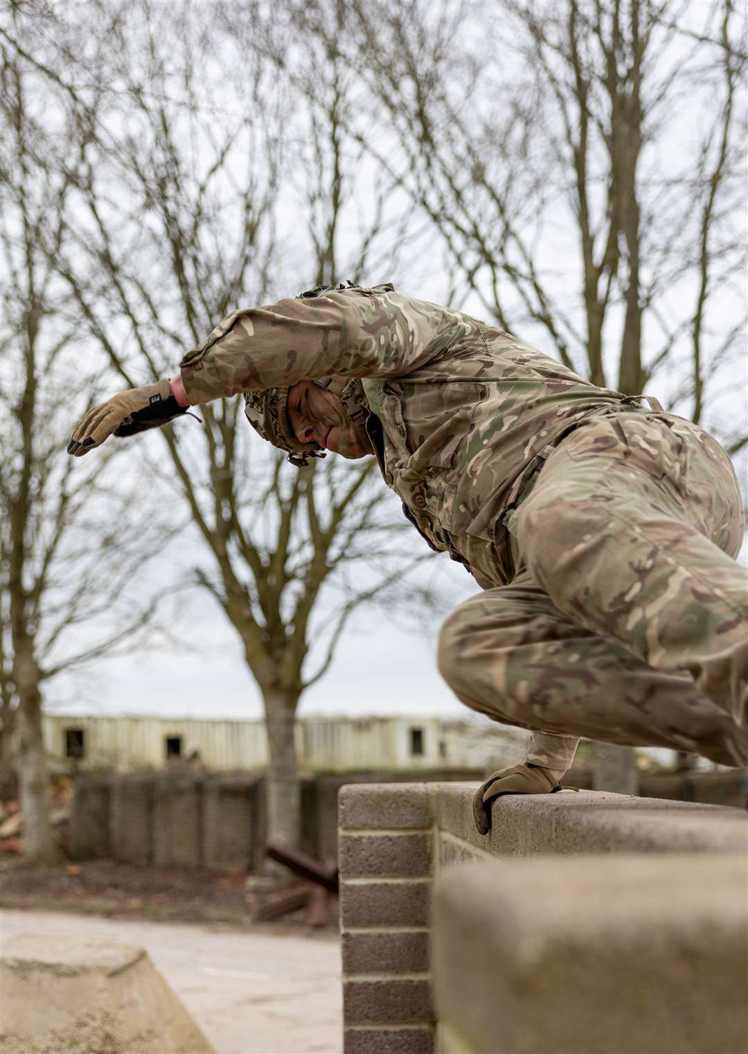 Sgt Hemmings leaps over the 4ft wall.