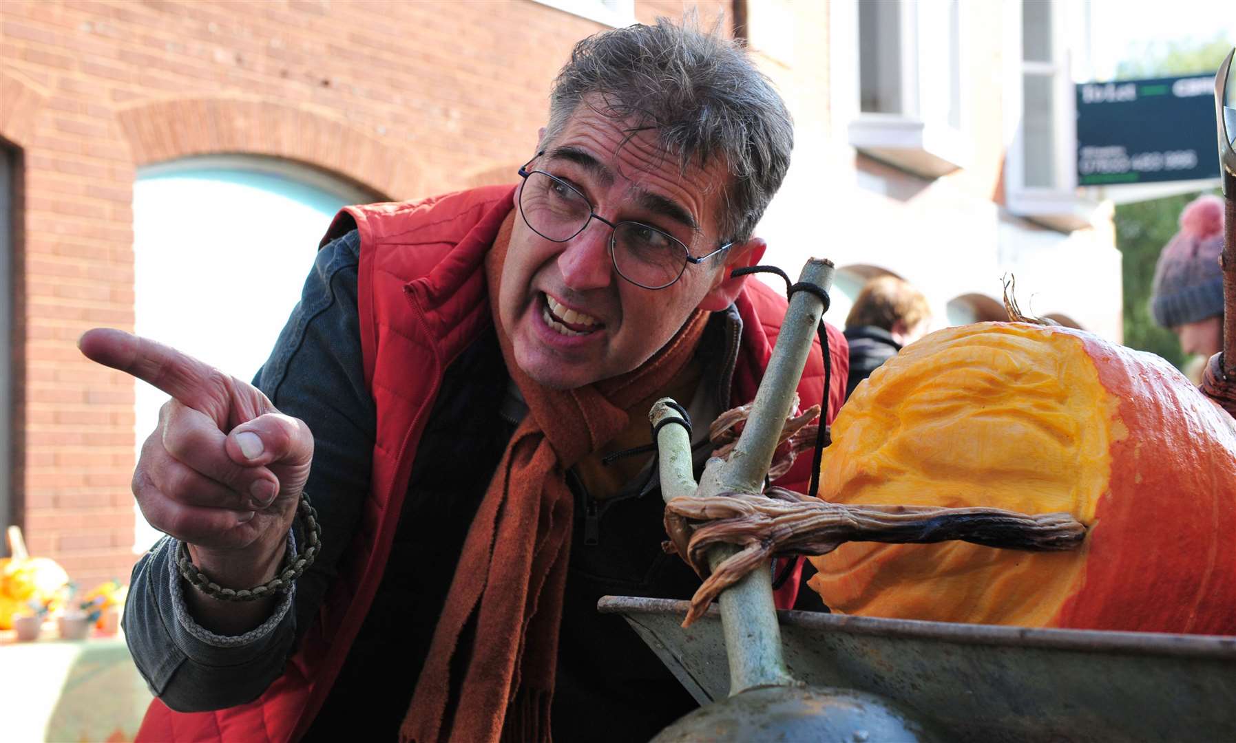 Artist Jonathan Nichols with some of his pumpkin statues