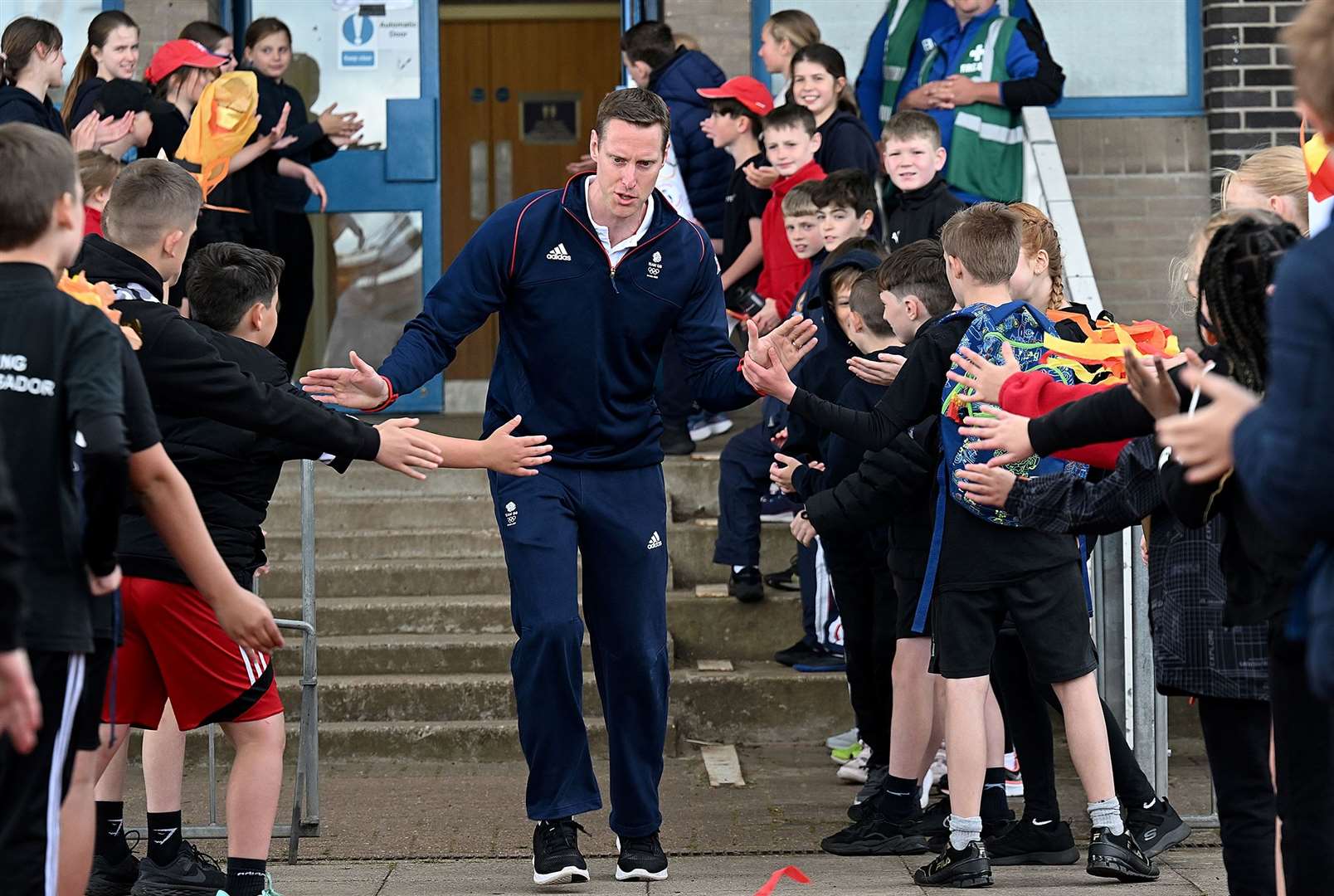 A high five for Jonathan Broom-Edwards as he runs through the crowd on day one.