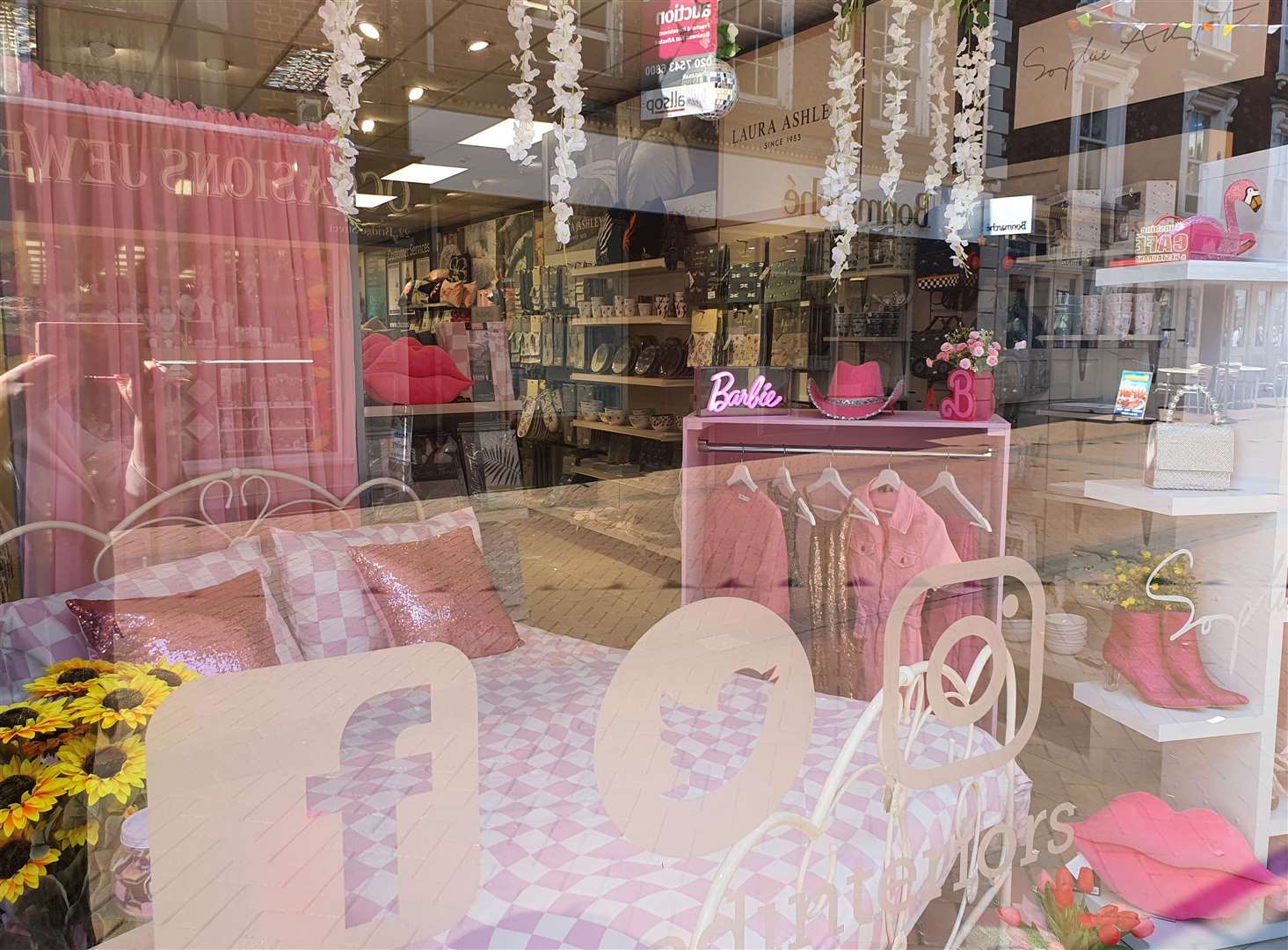 A Barbie themed window at Charmed Interiors