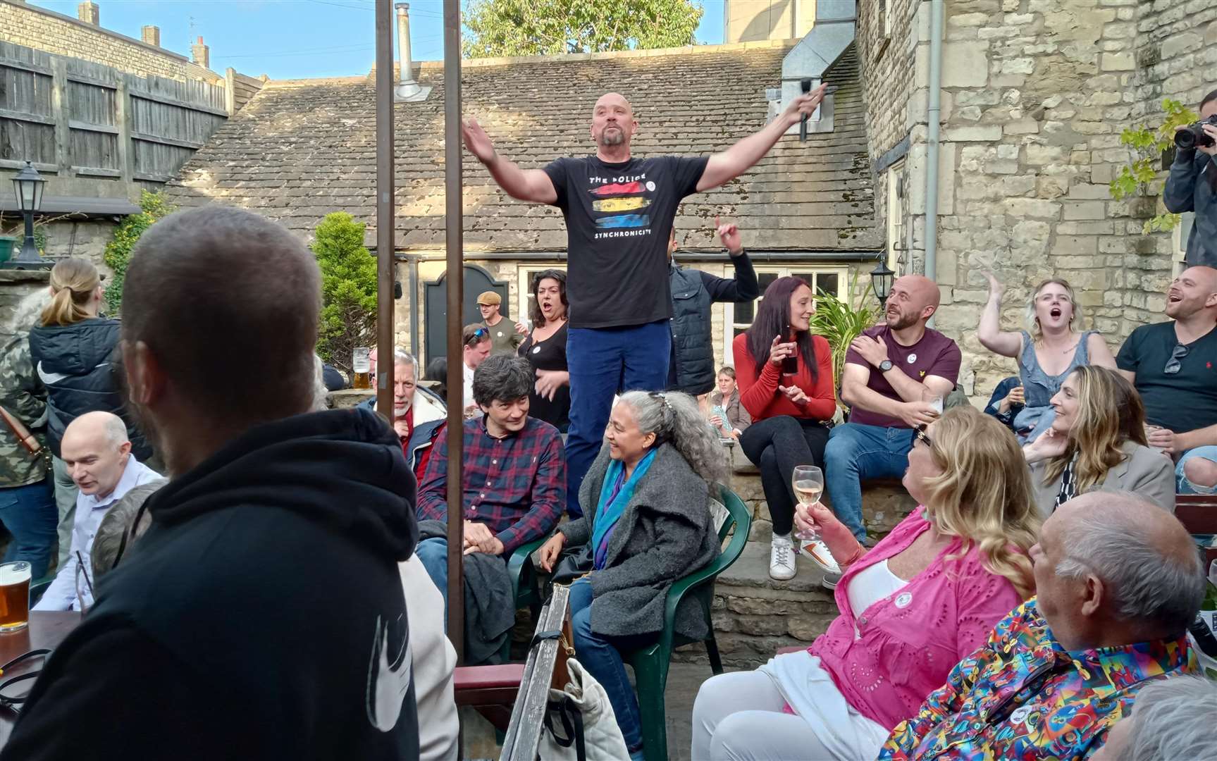 John Burton, lead singer of Listen Like Thieves entertains in the garden of the Lord Burghley