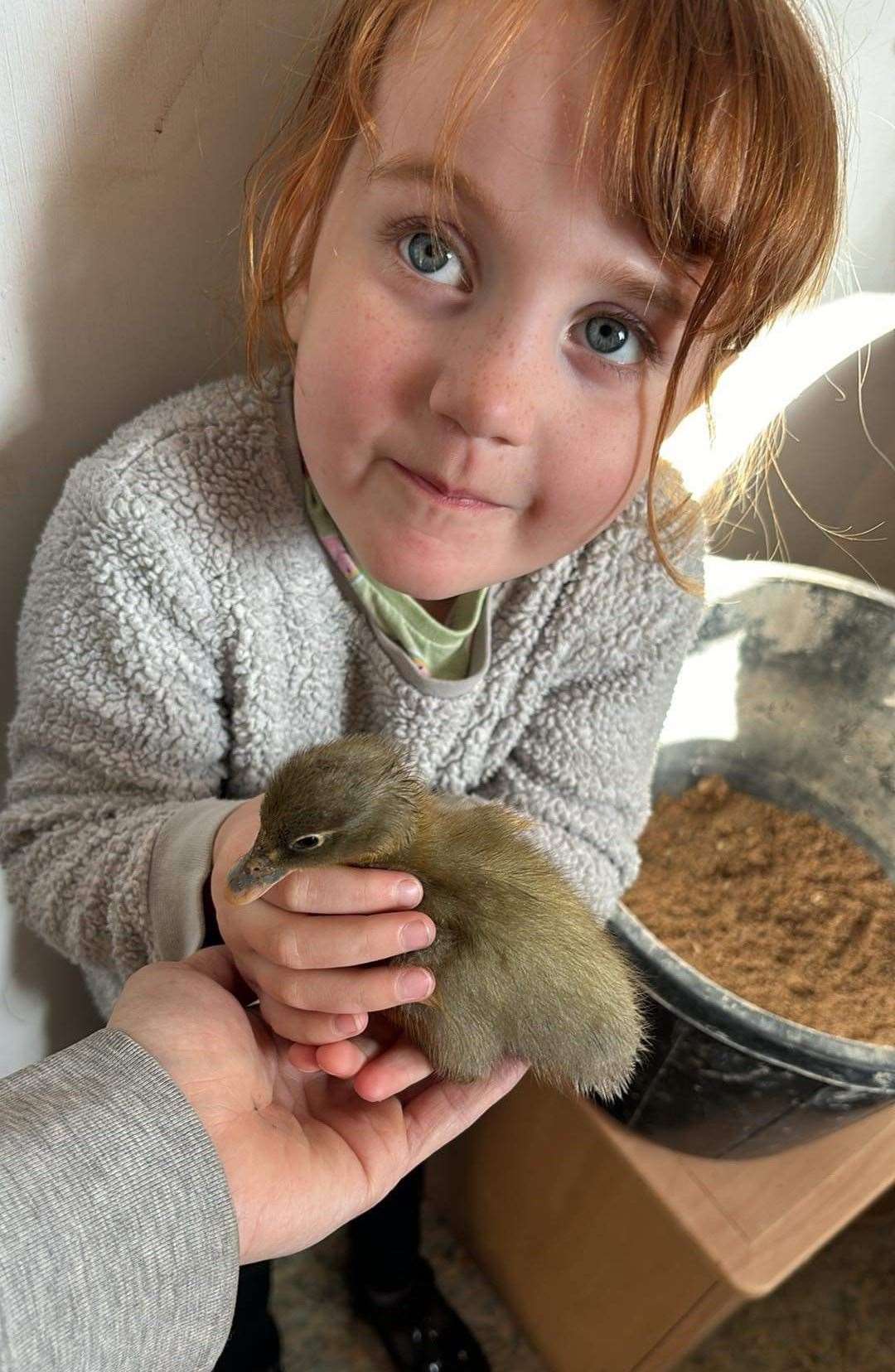 Danika's daughter with a baby duckling