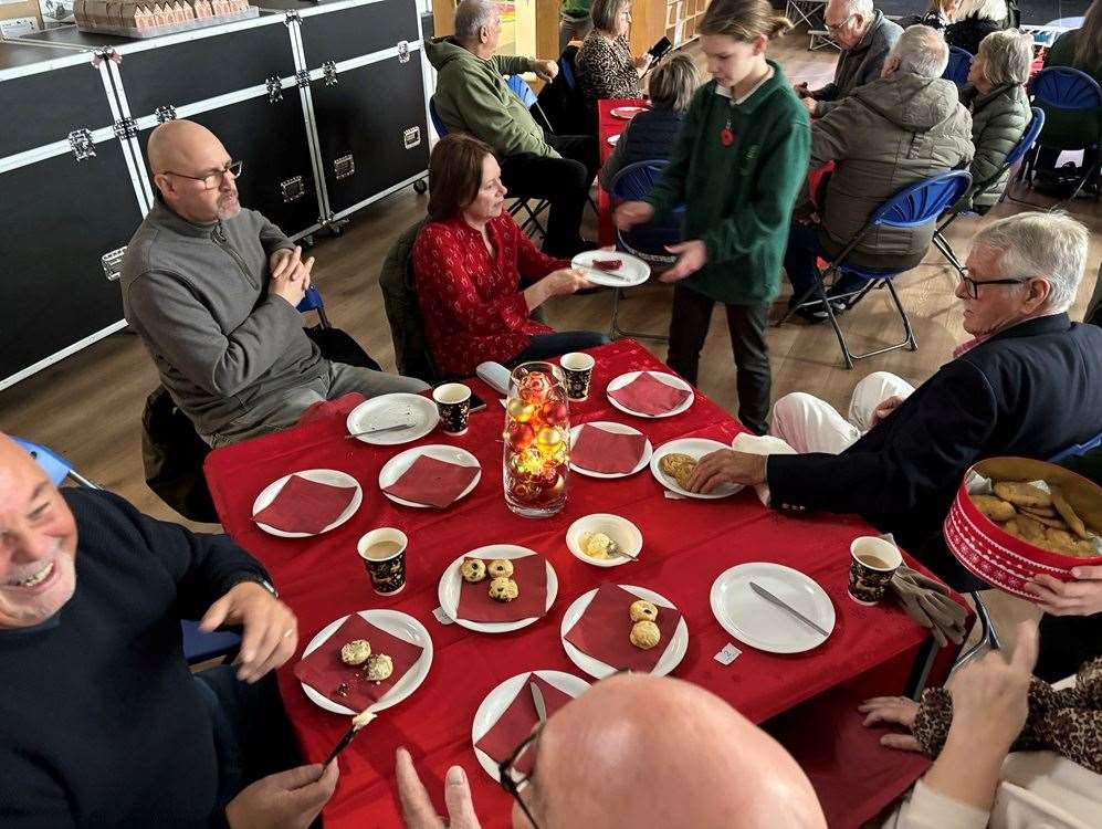 Some happy grandparents with their tea and cake.