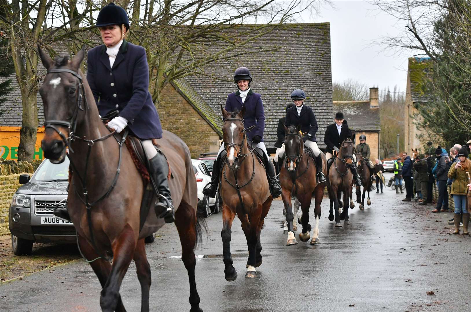 Hounds and riders leaving The Barn behind the Haycock Manor Hotel. Photo: David Lowndes