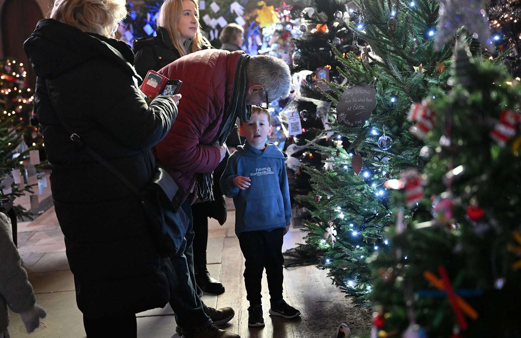 Visitors enjoying the St Wulfram's Christmas Tree Festival and skating rink.