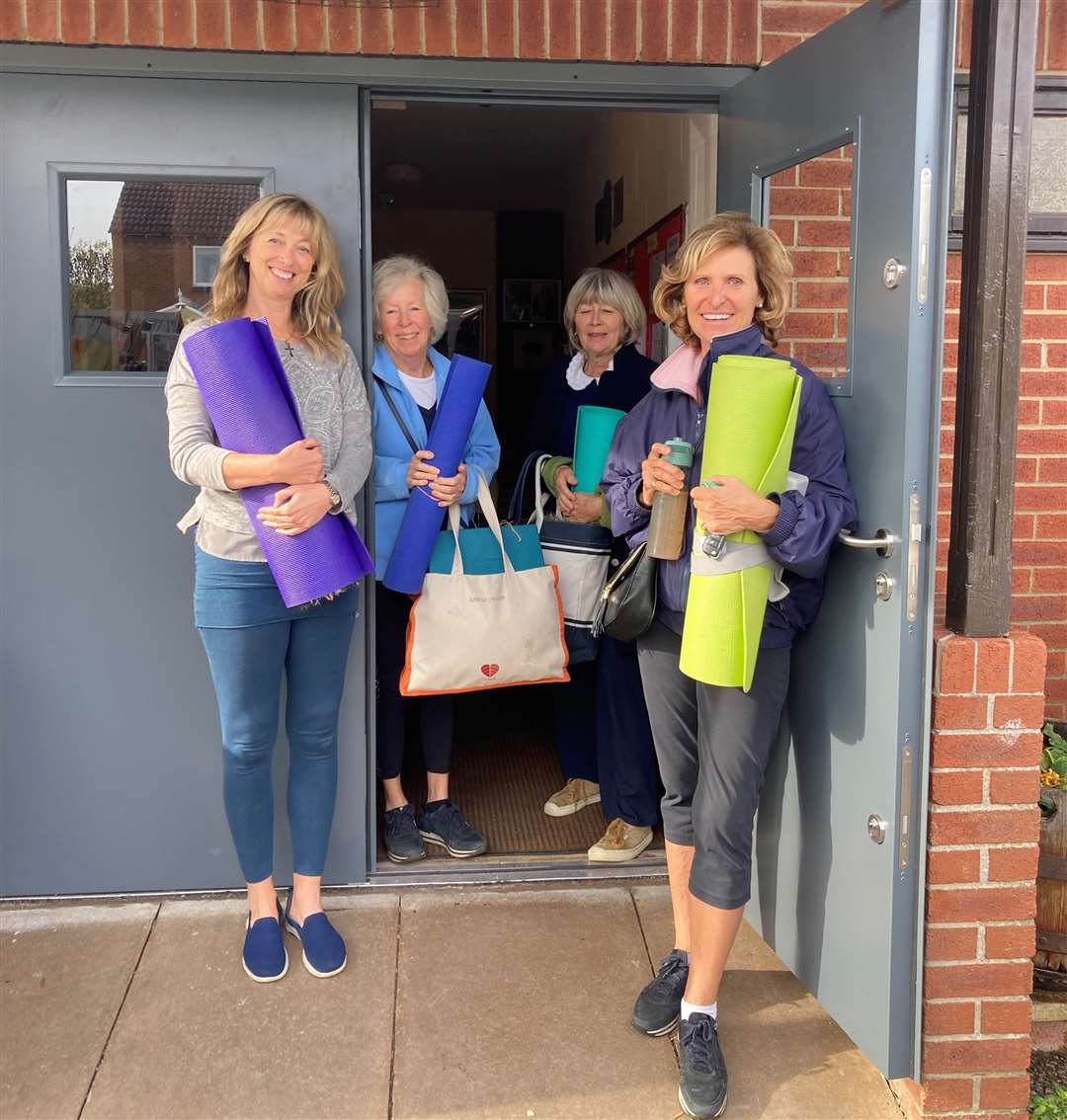 A yoga group stood next to the new doors at South Witham Village Hall