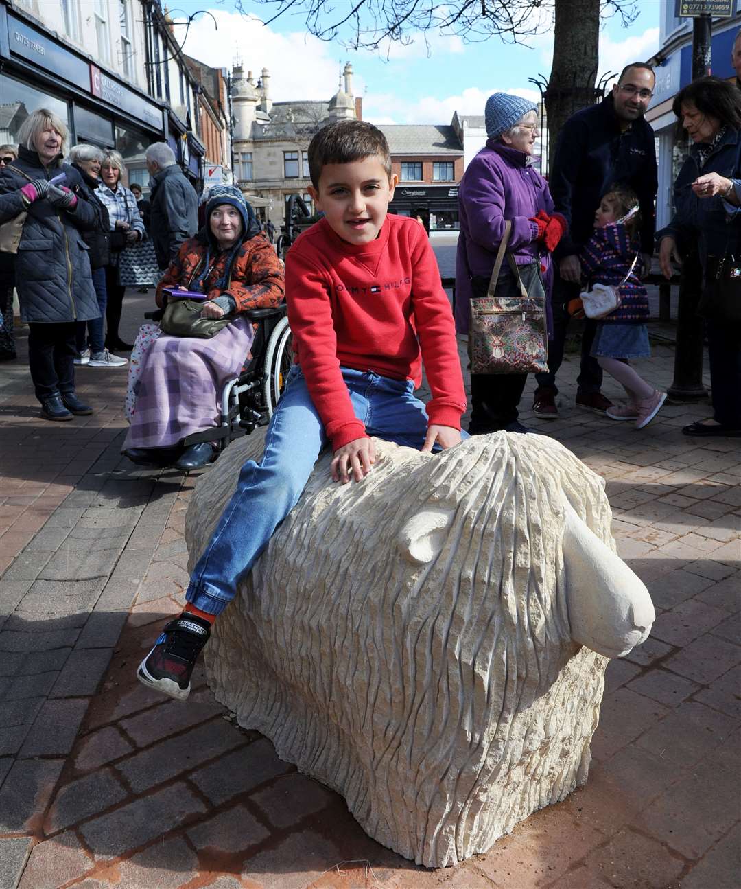 Miles Mahababi, 7, on one of the sheep