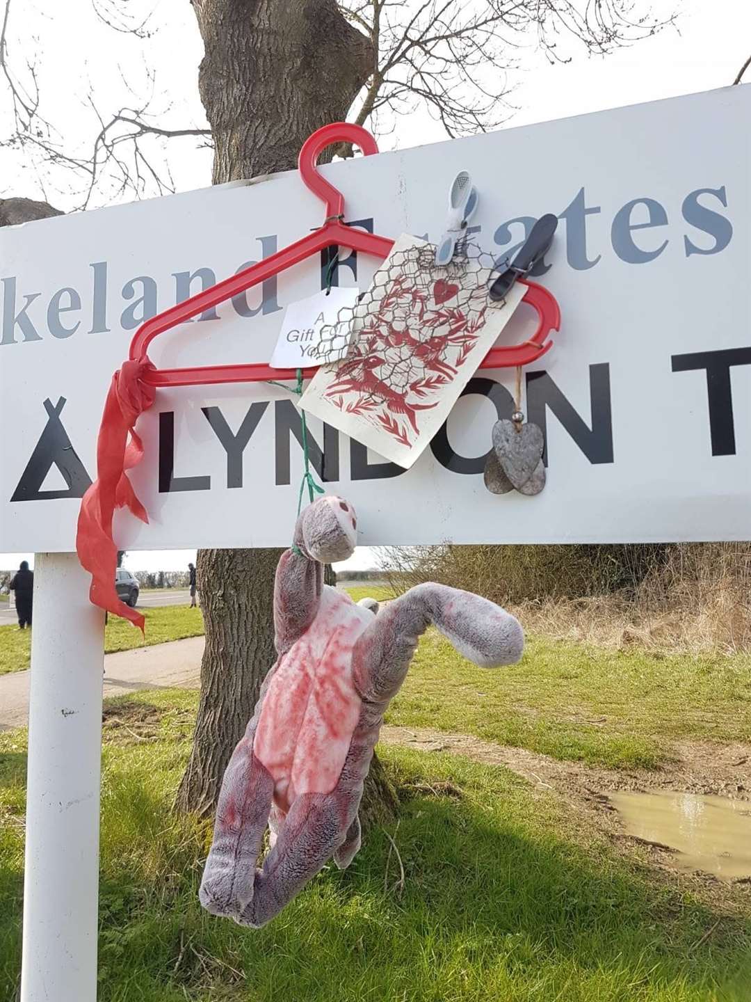 Protesters hung a stuffed toy rabbit over a sign