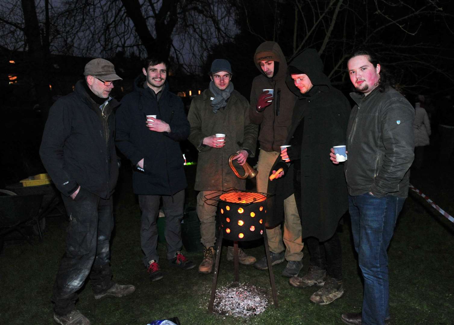 Keeping warm around the brazier. Photo: Chris Lowndes