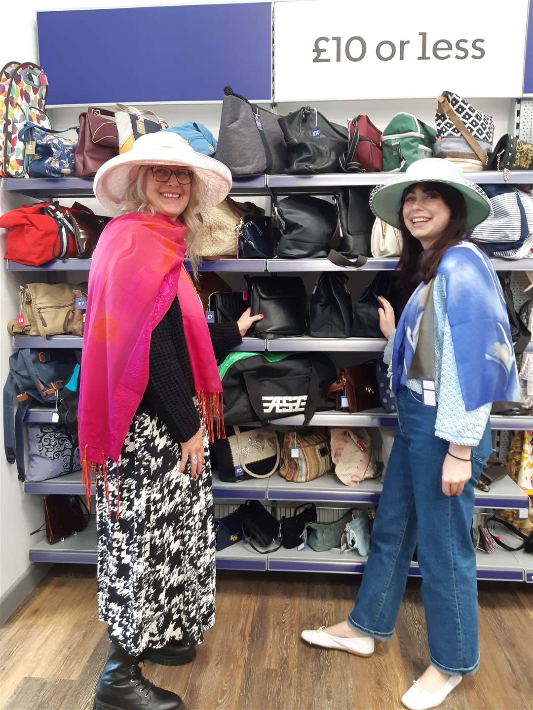 Shop assistants Dawn Bradley and Clarice Deakin model some hats and scarves that are in stock