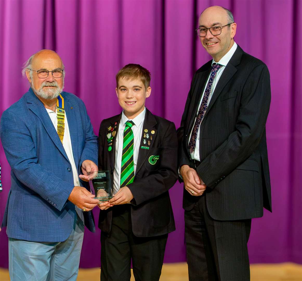 Bruce Strickland presenting Charlie with a writing competition prize in September, and Catmose College principal Stuart Williams