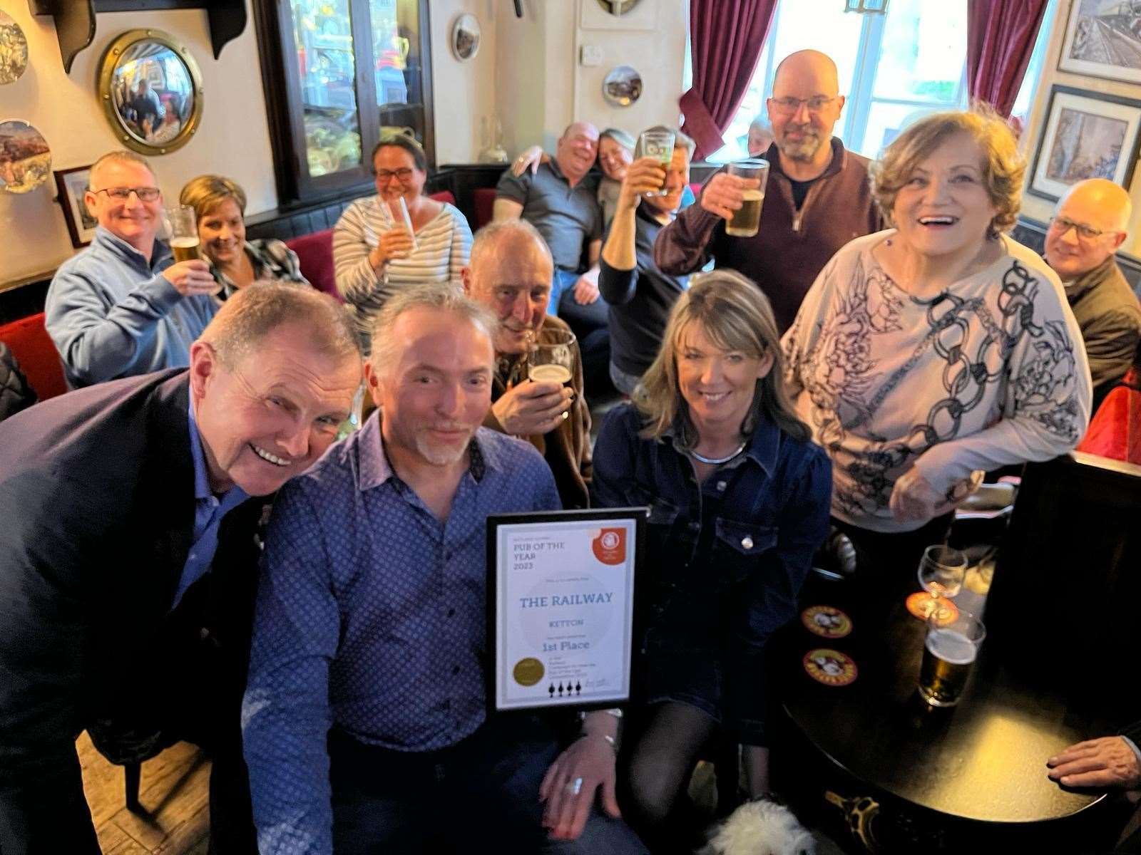 Camra members Rich Harris, Dave Casewell and Homera Wood with, front centre, pub landlords Jamie and Linda Betts, and several of their regulars enjoying drinks