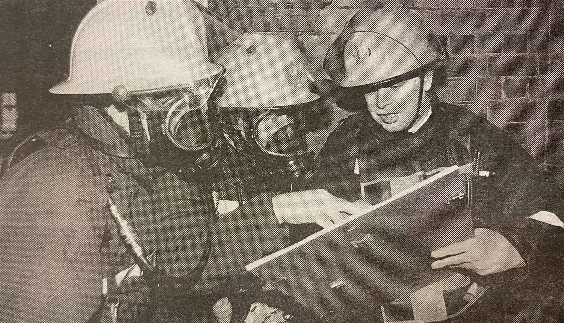 Two of the firefighters in breathing apparatus receive their instructions 25 years ago