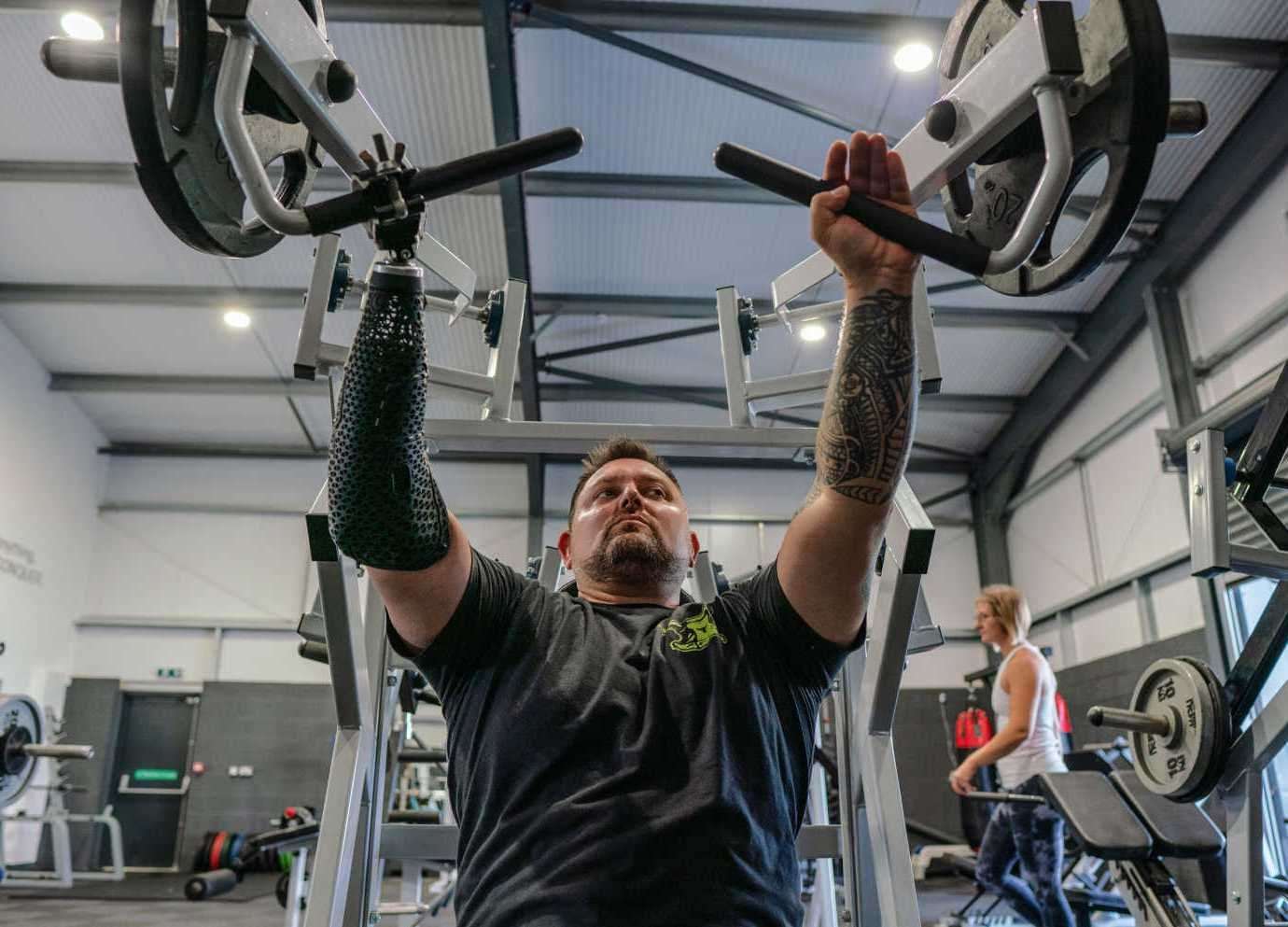John Whitman training for his bench press record attempt with his bionic arm.