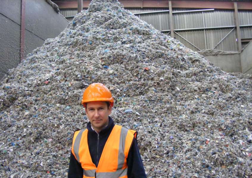 Managing Director of Mid UK Recycling, Chris Mountain, with a heap of shredded textiles destined for recycling as fuel. EMN-150112-135243001