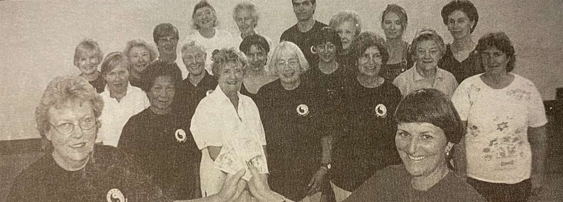 Sue Lawrence from the Red Cross happily accepts a cheque for £110 from the Taoist Tai Chi Society 25 years ago.
