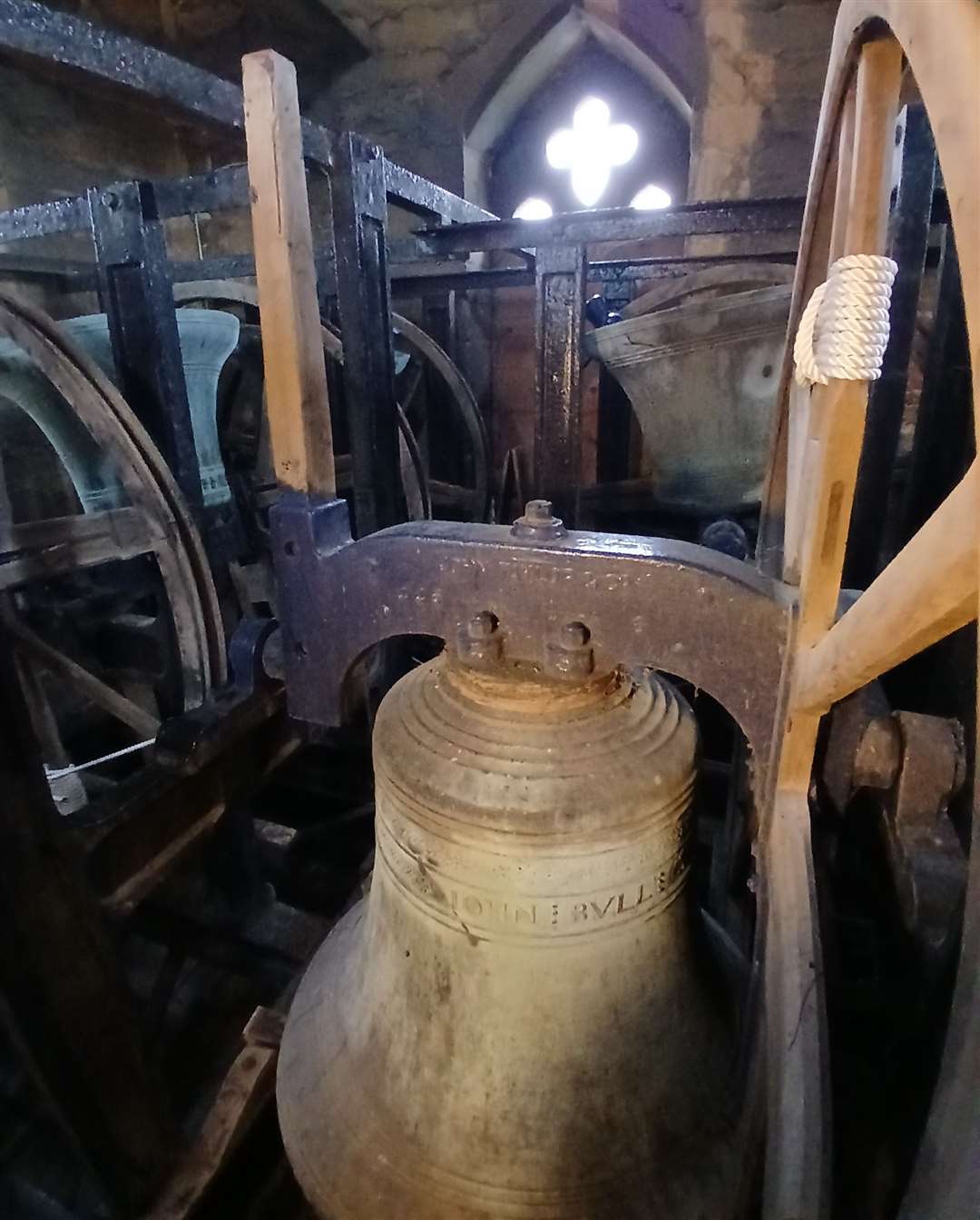 The tenor bell on its wheel with the 'stay' protruding on the top-left of the frame