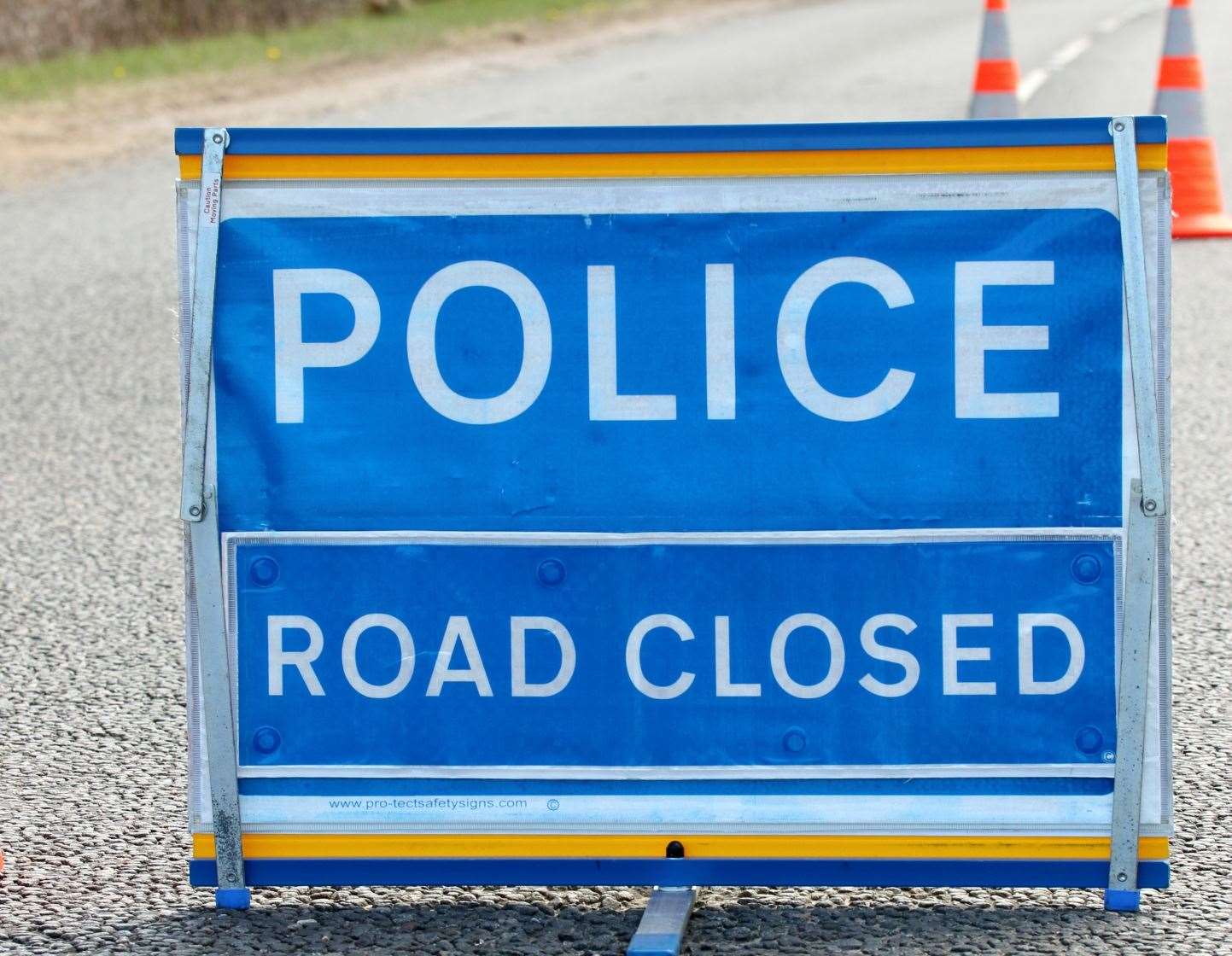 A police road closed sign