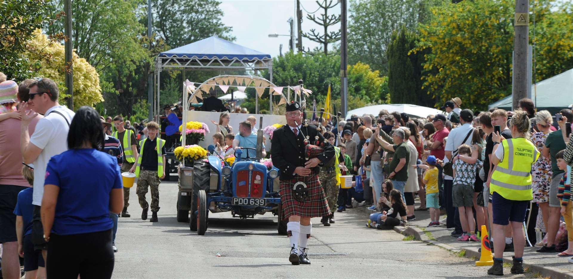The piper leads the way on a sunny day