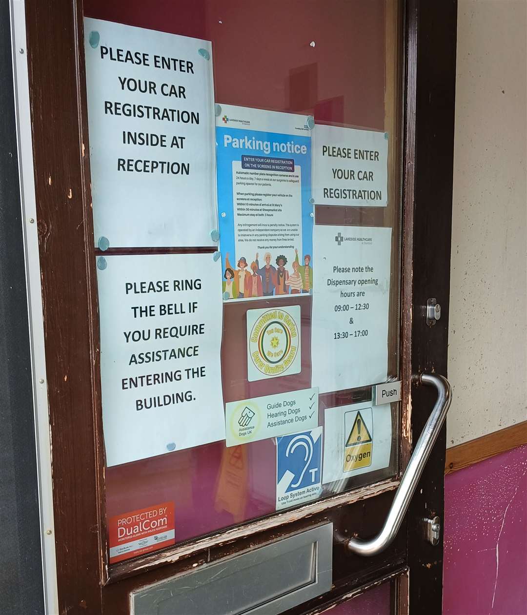 Three notices are tacked to the front door, although this is sometimes propped open