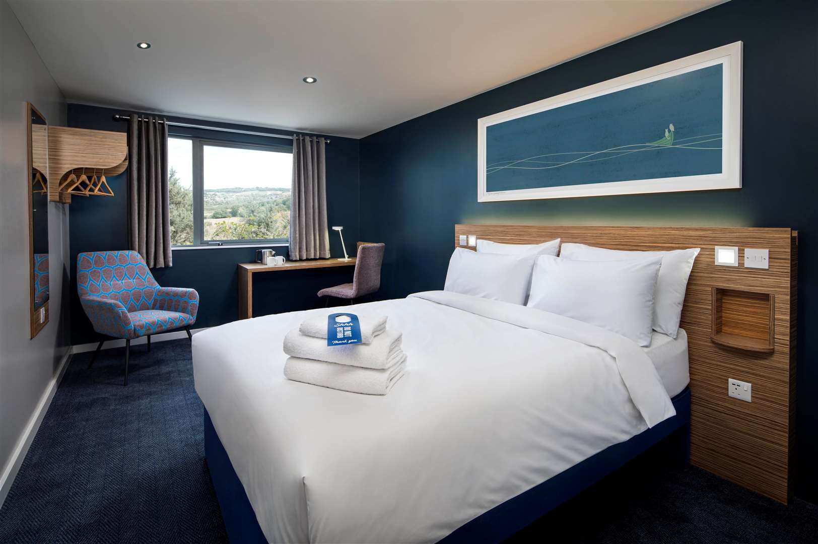 Upgraded features include a desk and chair and blackout curtains to create a good night’s sleep