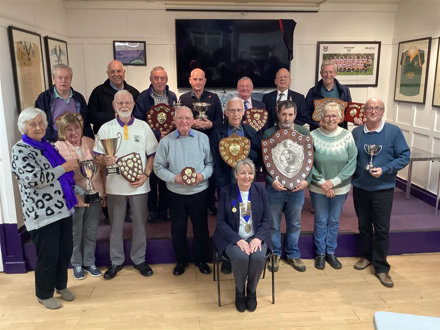 Rita Downs (president) is pictured with some of the 2023 Stamford Bowls League trophy winners at the annual meeting.