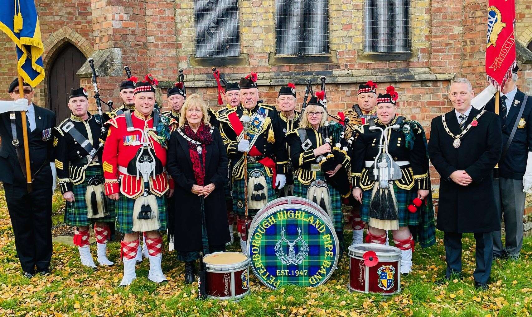 South Holland District Council chairman Coun Andrew Woolf and vice-chair Coun Jan Whitbourn with veterans and the band at the Weston Hills Remembrance event