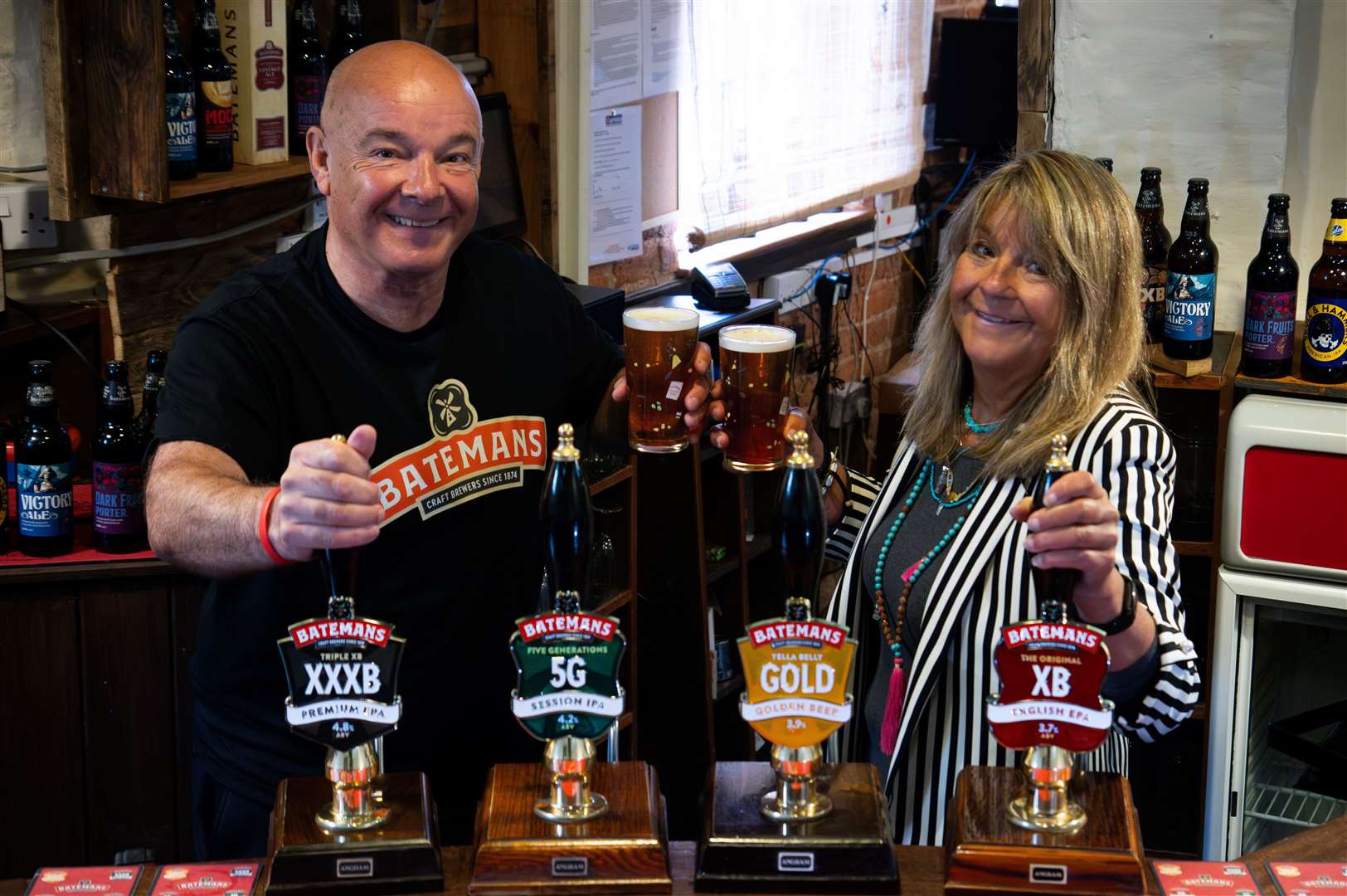Batemans Brewery - Stuart & Jaclyn raise a glass to the next 150 years. They are pictured in Mr George's Bar Photo: BATEMANS BREWERY