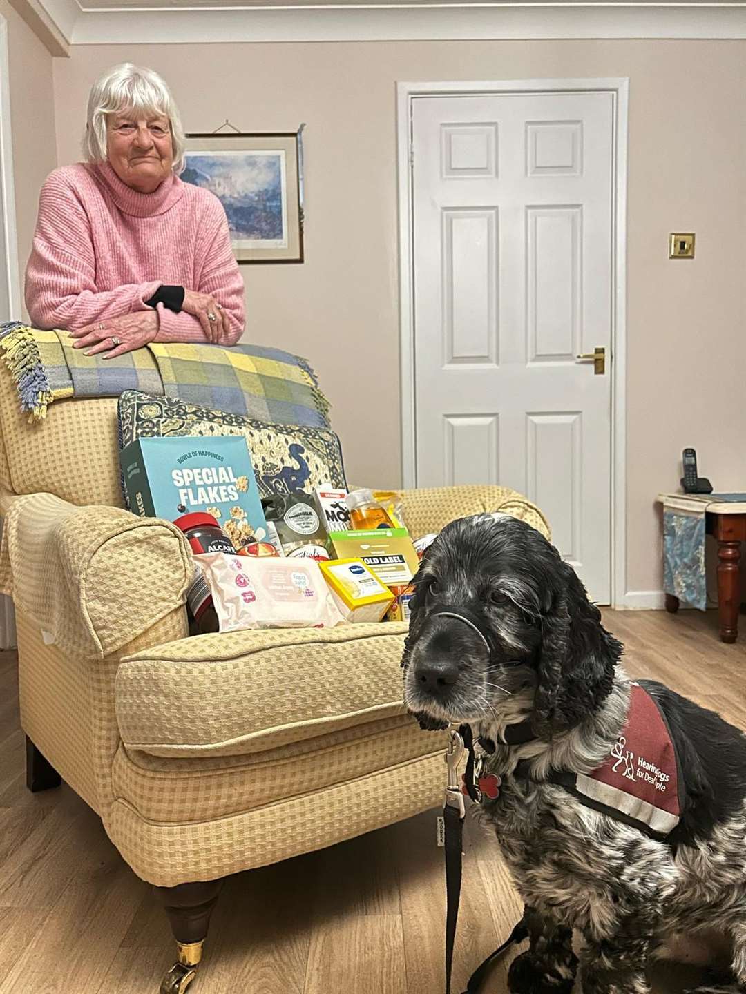 Sue Clement and hearing dog Wesley with just some of the items they have collected so far for Grantham Foodbank. Photo: Supplied