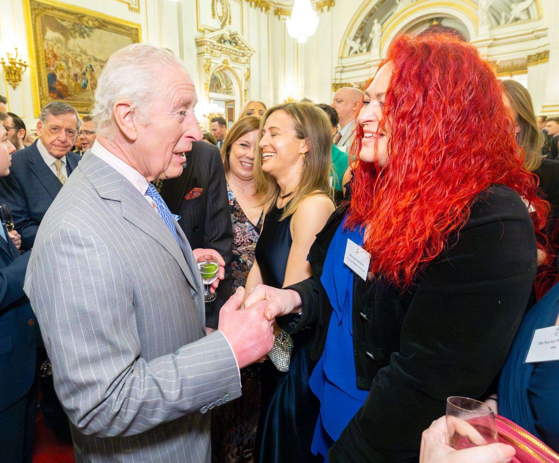 King Charles III meets Grantham's Suzie Stevens at Buckingham Palace.