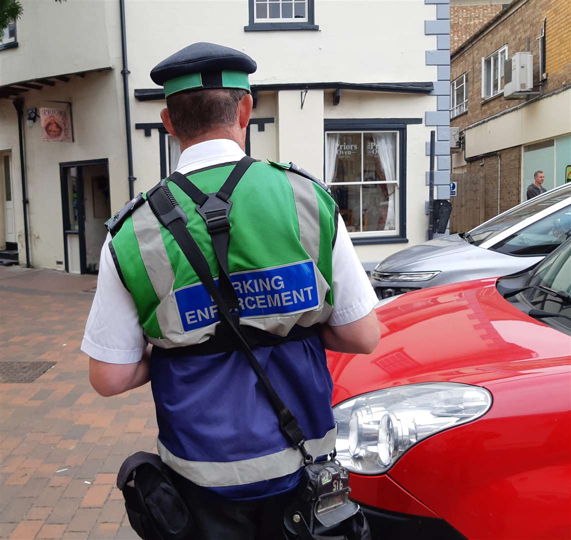 A parking enforcement officer patrols Spalding's Sheep Market on Tuesday.