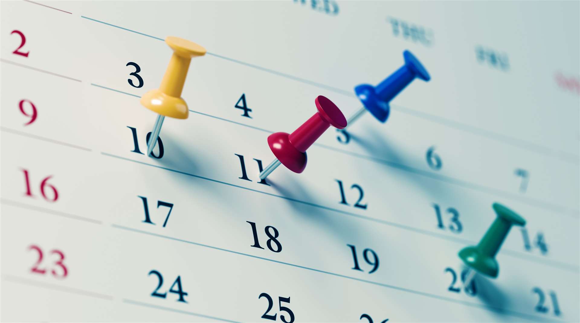 Calendar with coloured push pins. Photo: istock