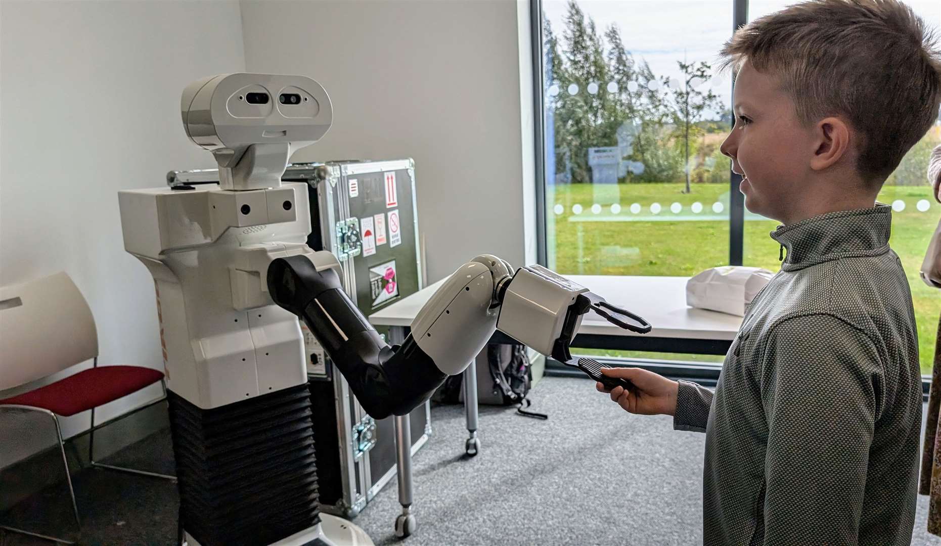 A youngster gets to meet a robot at the open day. PHOTO: SUBMITTED