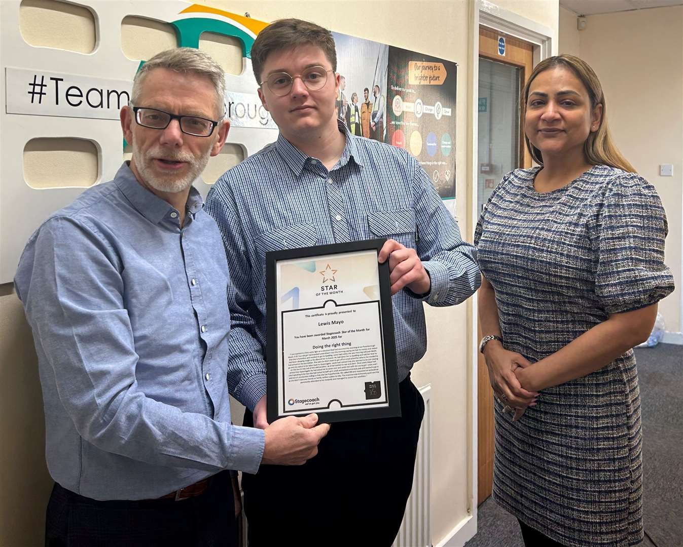 Hero bus driver Lewis Mayo is seen receiving his Stagecoach Star of the Month Awardfrom Darren Roe (left) and Hema Russell (right)