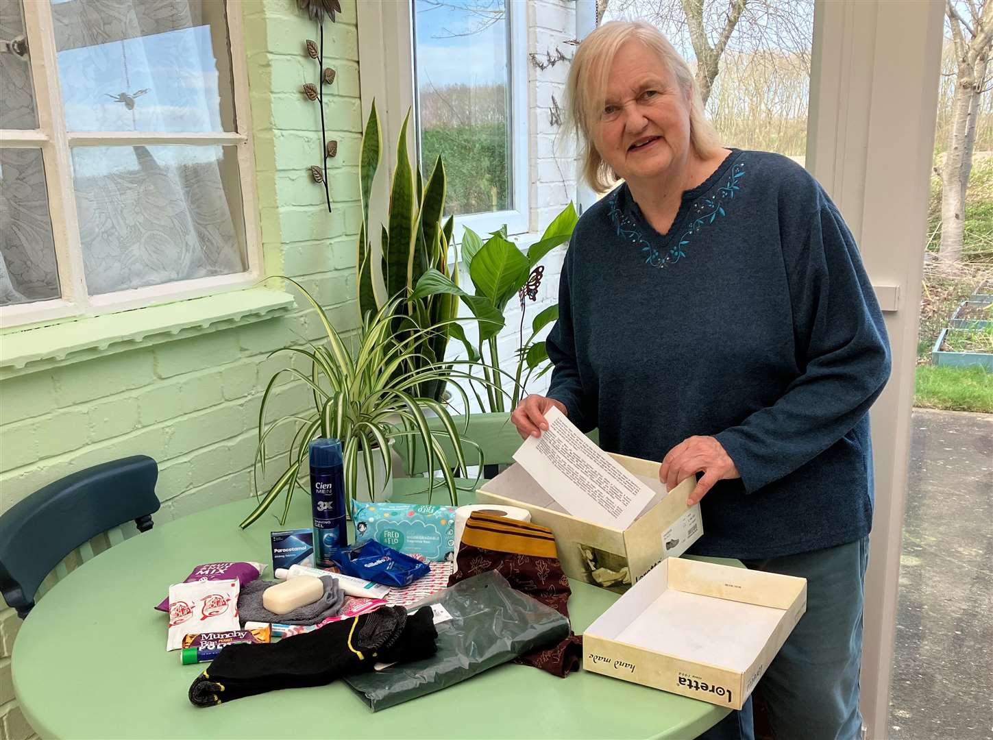 Former poet laureate of Stamford, Theresa McLean, packs a box of hope for Ukraine