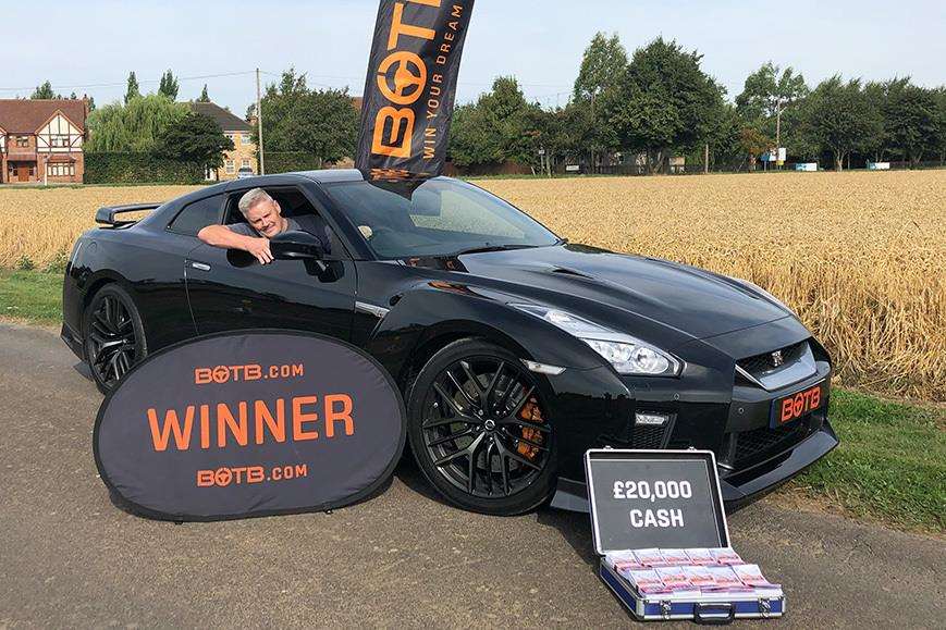 Andy in his dream car with £20,000 nearby. (3571190)